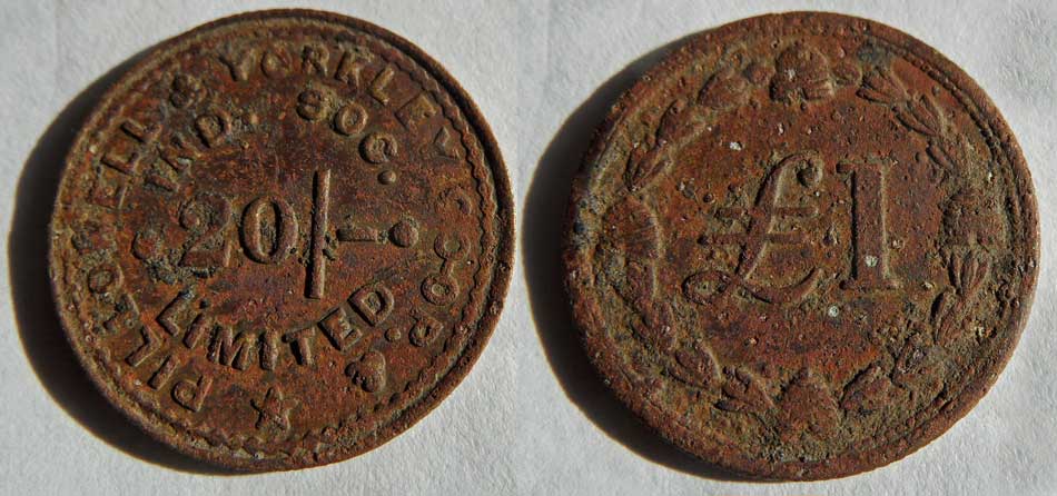 A photo of two old Pillowell and Yorkley Coop tokens