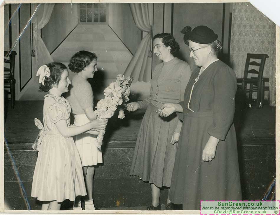 An old photo of a presentation to Matron Bowden.
