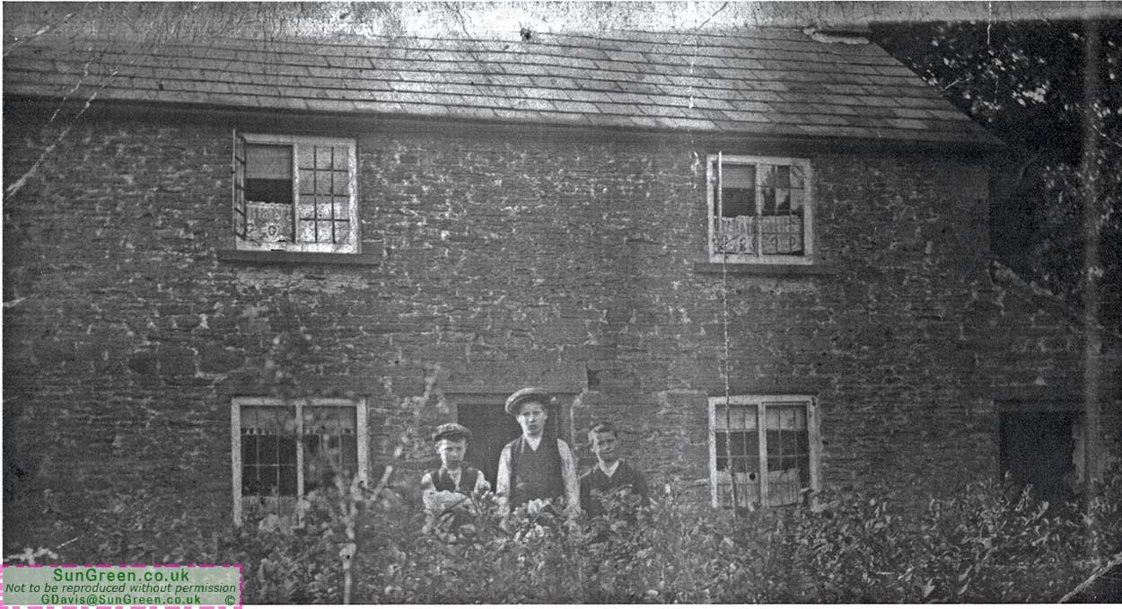 A photo of three people outside Rose Cottage