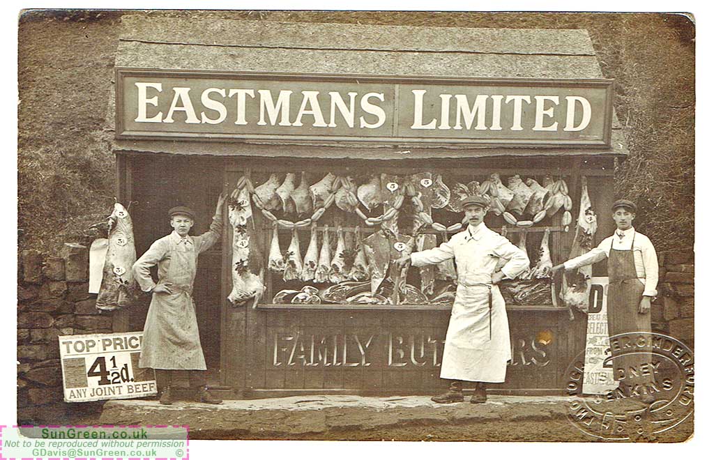 A photo of men standing outside Eastman's shop in Cinderford