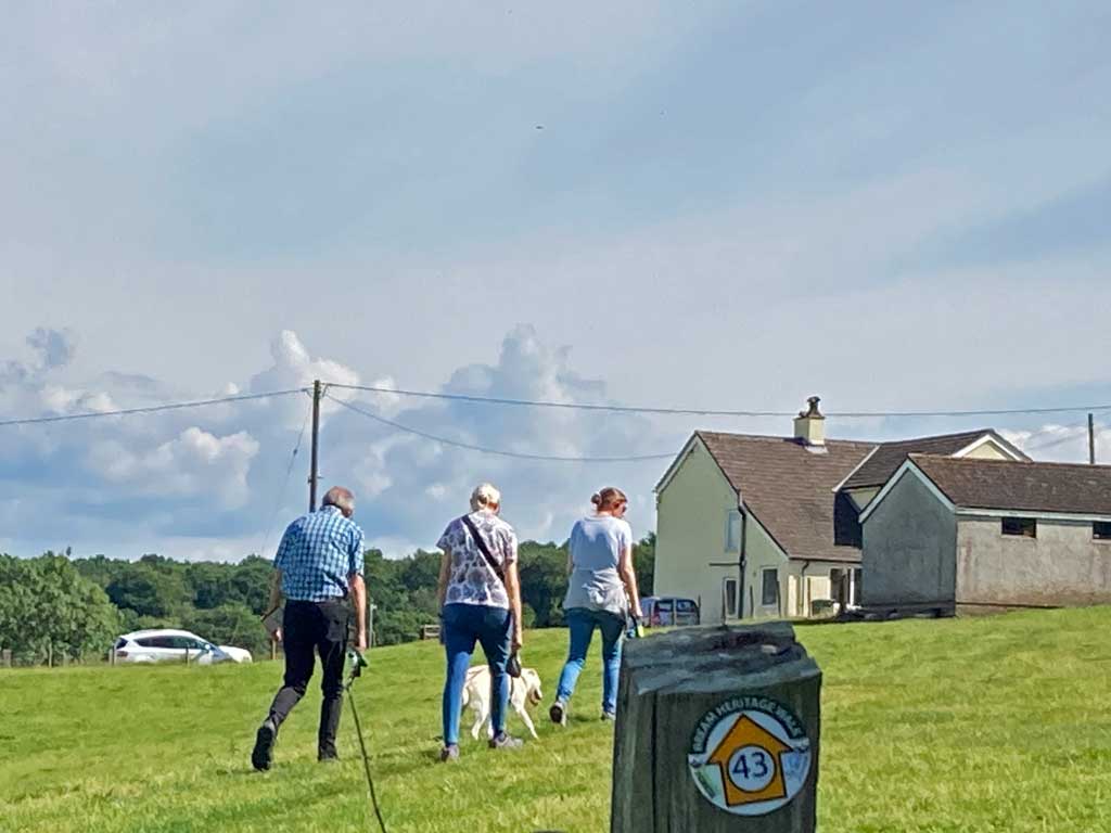 A photo showing 3 people walking towards Brockhollands from Saunders Green
