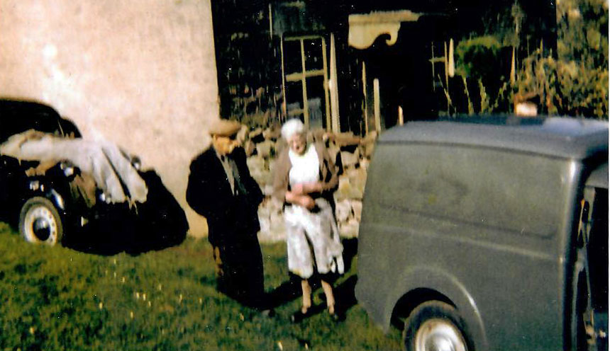 A photo of people and cars outside Bannock Tree Cottage.