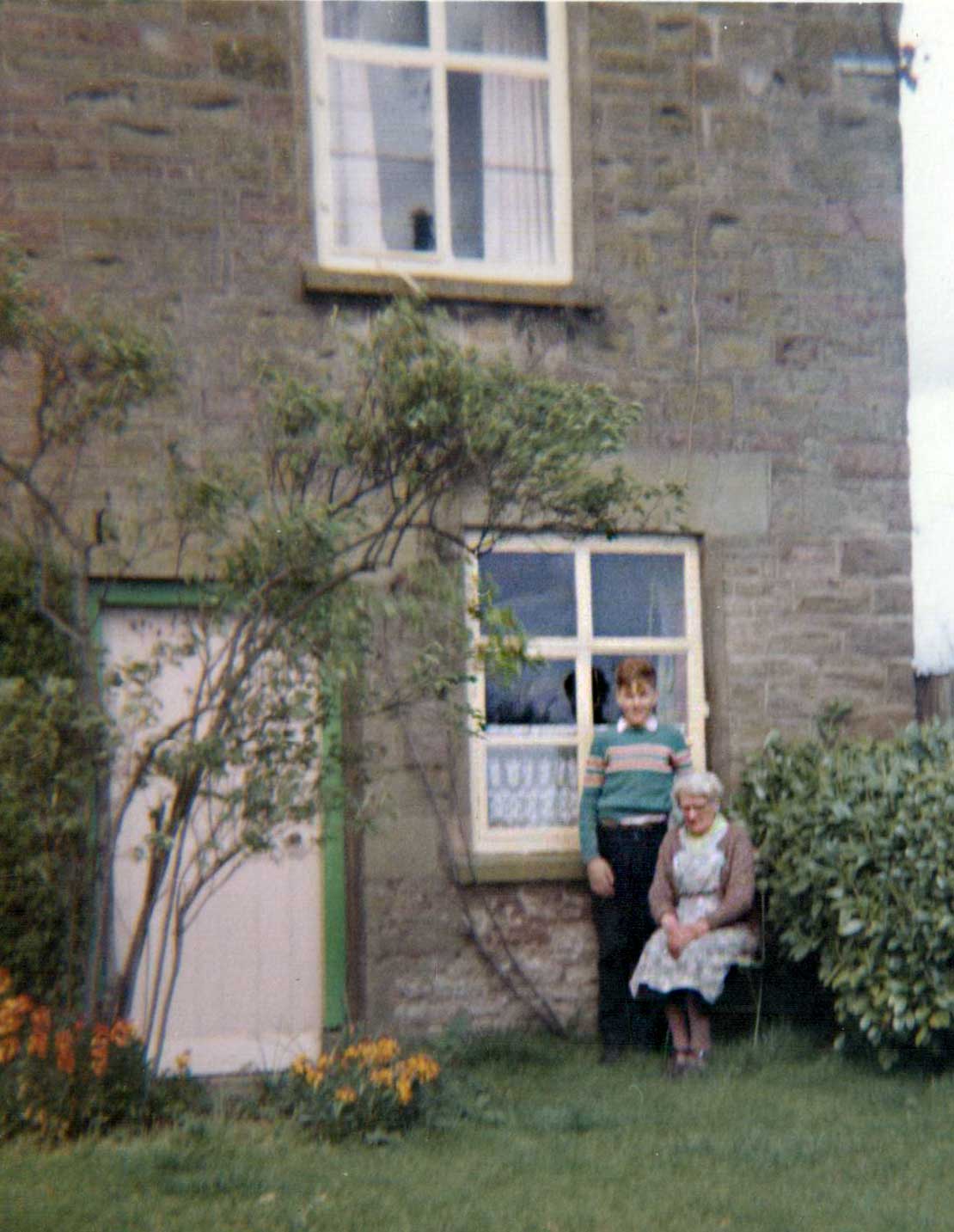 A photo of people at the front door of Bannock Tree Cottage.