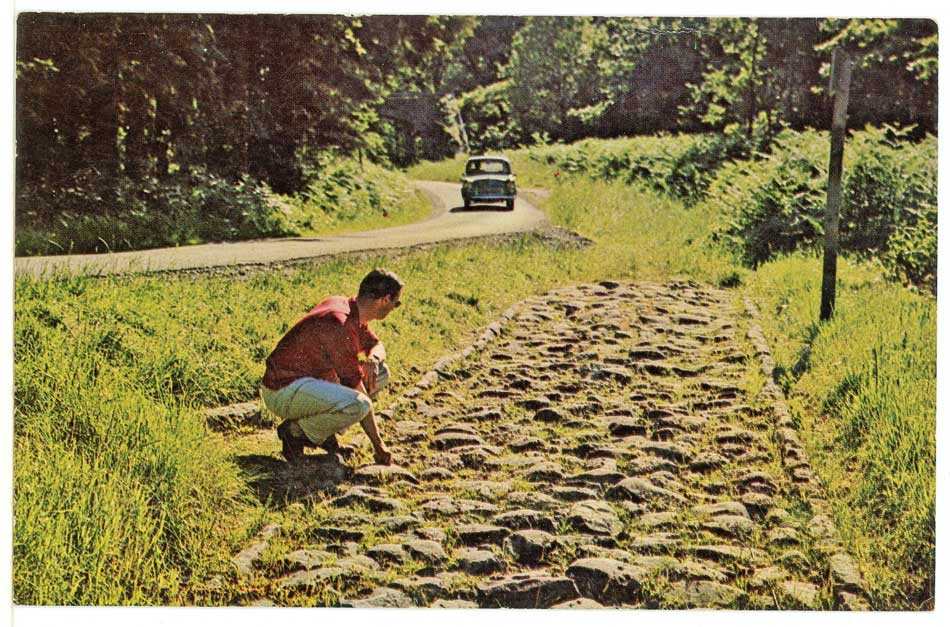 A photo of a man and a car at The "Roman Road" near Wenchford, Blakeney, Gloucestershire.